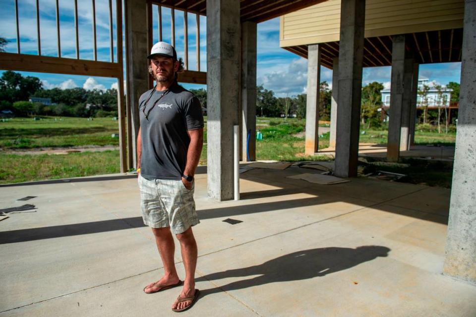 Mike Butler, a developer of The Sands housing project, stands at the base of one of his unfinished townhouses on Front Beach in Ocean Springs on Thursday, Oct. 14, 2021.