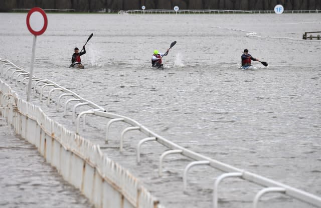 Kayakers on a flooded Worcester racecourse