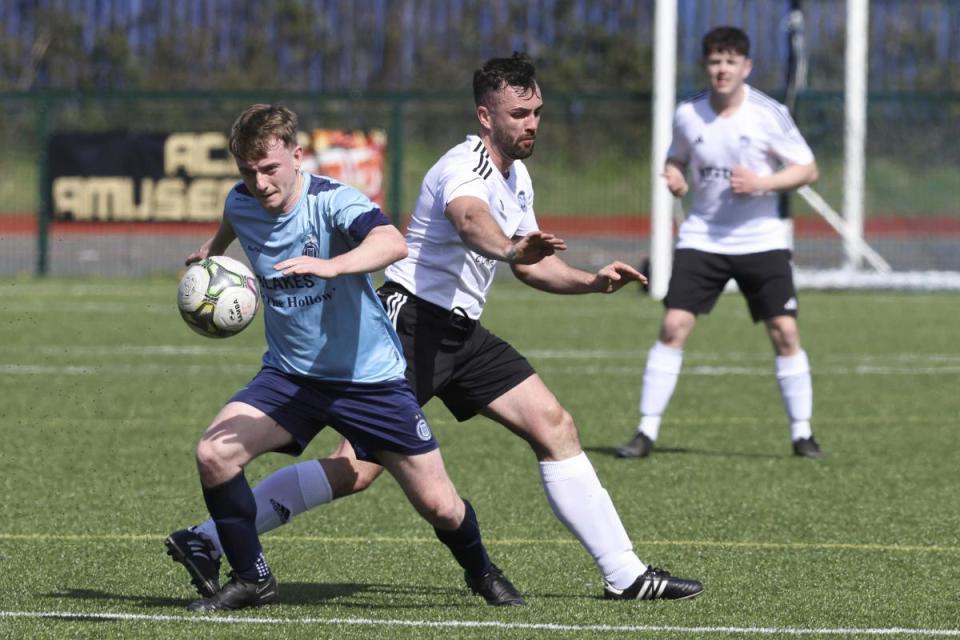 Town's Brendan Lilley gets away from Athletic's Daniel Goan. <i>(Image: Donnie Phair.)</i>