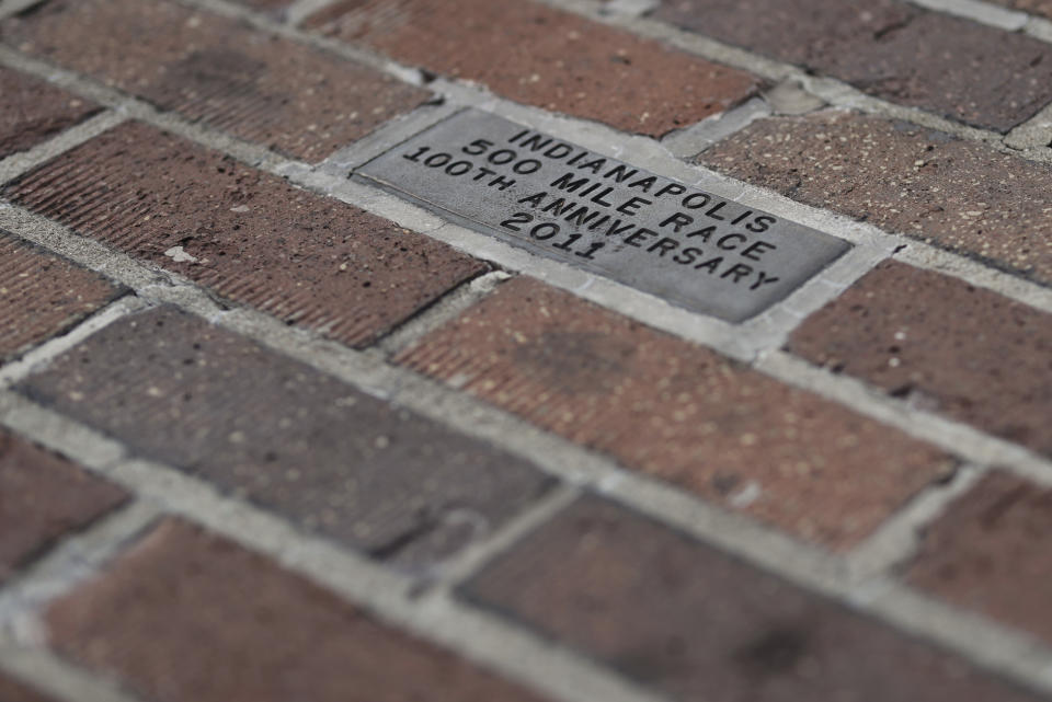 A message honoring the 100th anniversary of the Indianapolis 500 is located in the middle of the "Yard of Bricks" at the Indianapolis Motor Speedway, Sunday, May 24, 2020, in Indianapolis. (AP Photo/Darron Cummings)