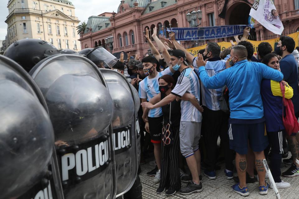 <p>Hundreds of fans were confronted by police as they pushed to see Diego Maradona’s coffin inside the presidential palace in Buenos Aires</p>AP