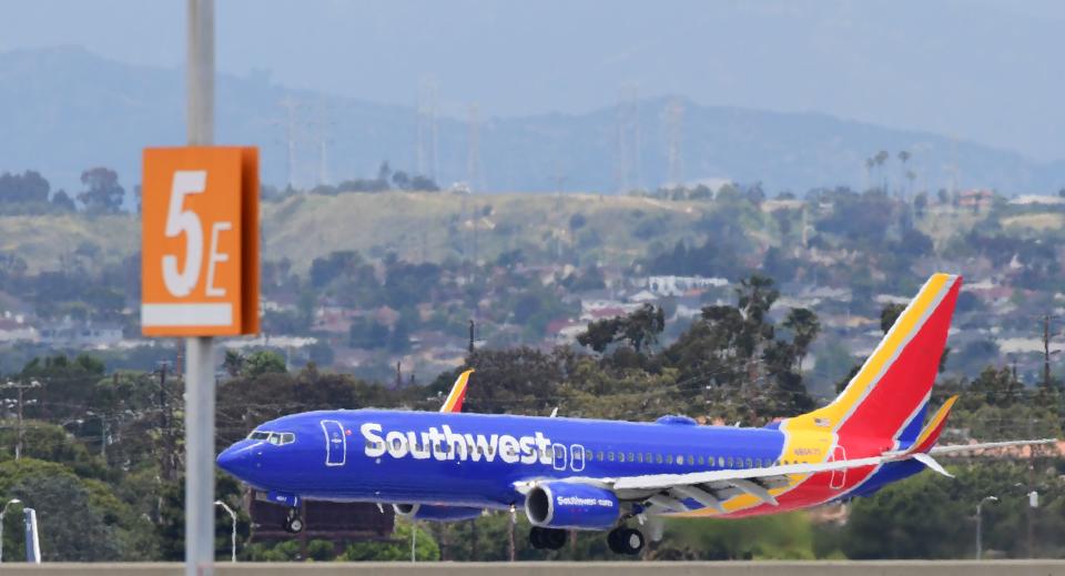 A Southwest Airlines airplane comes in for a landing at Los Angeles International Airport on May 12, 2020 in Los Angeles, California. - The airline and travel industries have been devasted by the coronavirus pandemic as Stay-at-Home orders in Los Angeles, due to end in mid-May, have been extended to July. (Photo by Frederic J. BROWN / AFP) (Photo by FREDERIC J. BROWN/AFP via Getty Images)