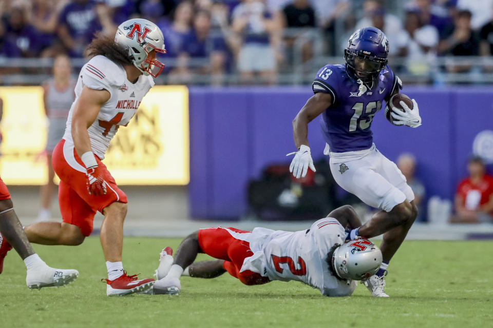TCU wide receiver Jaylon Robinson (13) is brought down by Nicholls State defensive back Tyler Morton (2) during the first half of an NCAA college football game, Saturday, Sept. 9, 2023, in Fort Worth, Texas. (AP Photo/Gareth Patterson)