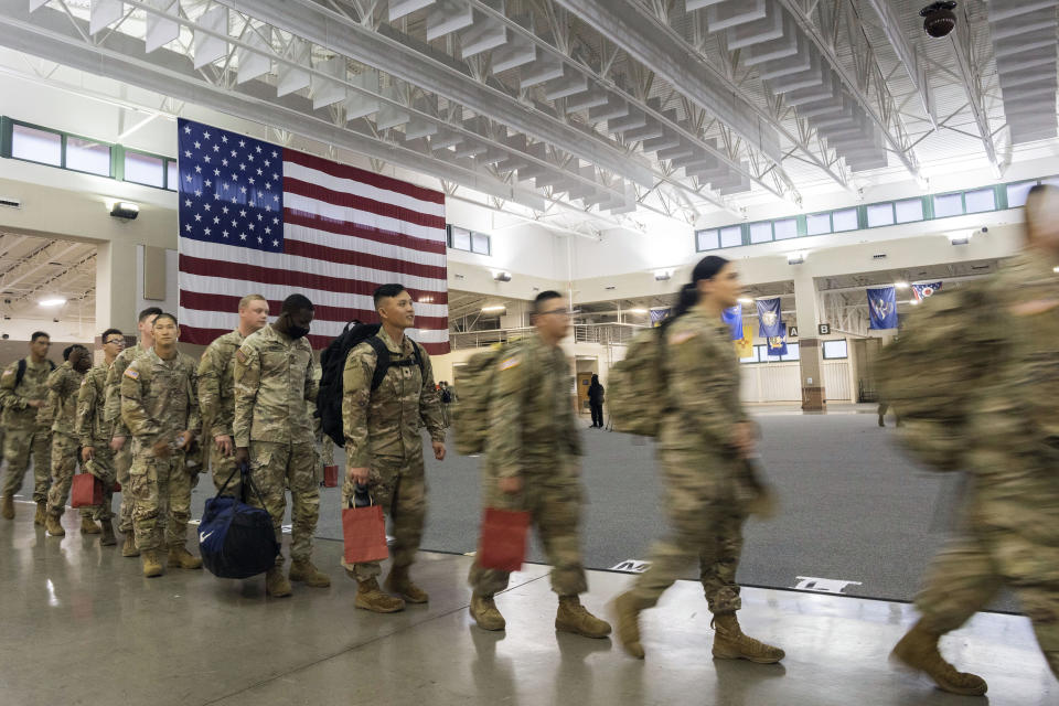 About 130 soldiers wait to board a chartered plane at Hunter Army Airfield in Savannah, Ga., during their deployment to Europe on March 11, 2022. 