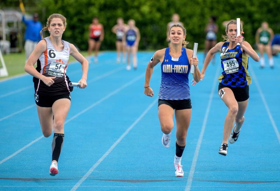 Byron's Ava Milburn (54) outruns Maroa-Forsyth's Livia Binder, middle, and Rockford Christian's Avery Demo to victory in the 4X100-meter relay during the Class 1A State Track and Field Championships on Saturday, May 21, 2022 at Eastern Illinois University. Byron took the title while Maroa-Forsyth took second and Rockford Christian finished fourth.