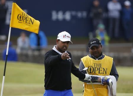 Anirban Lahiri of India speaks with his caddie on the first green during the final round of the British Open golf championship on the Old Course in St. Andrews, Scotland, July 20, 2015. REUTERS/Phil Noble