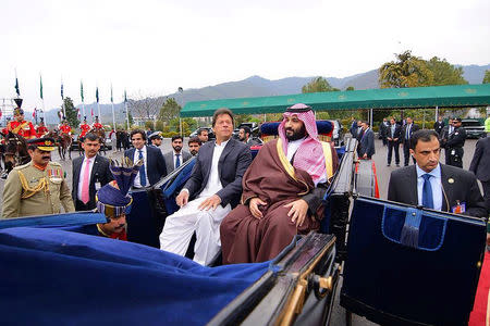 Pakistani Prime Minister Imran Khan accompanies Saudi Arabia's Crown Prince Mohammed bin Salman on a carriage to the President House in Islamabad, Pakistan February 18, 2019. Press Information Department (PID)/Handout via REUTERS/