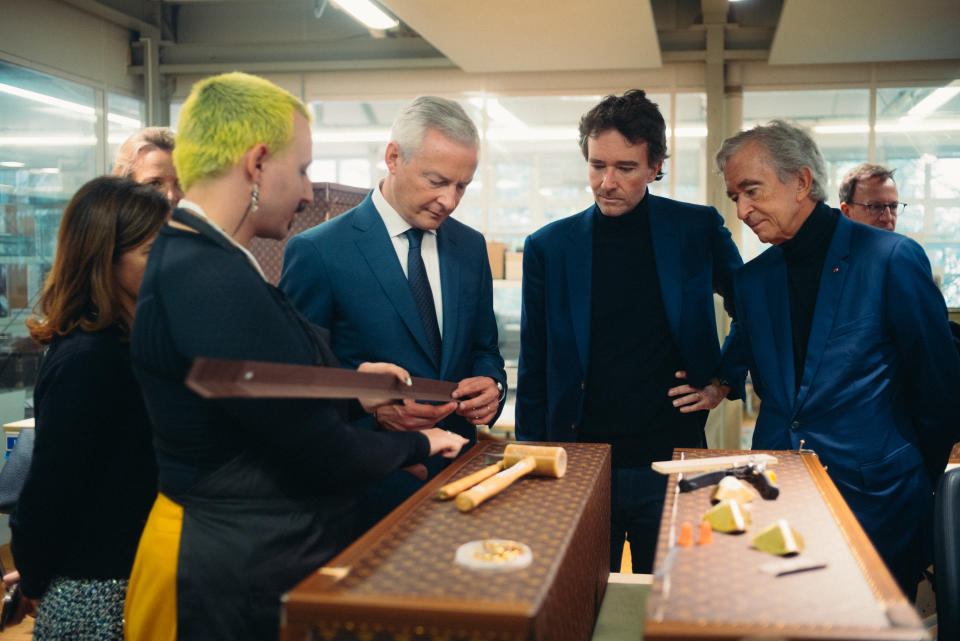 Antoine and Bernard Arnault watching trunk makers at work at Louis Vuitton.