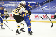 Buffalo Sabres defenseman Rasmus Dahlin (26) and Boston Bruins forward David Pastrnak (88) collide during the first period of an NHL hockey game, Tuesday, April 20, 2021, in Buffalo, N.Y. (AP Photo/Jeffrey T. Barnes)