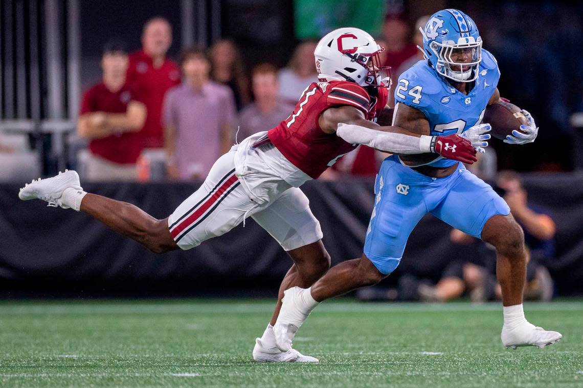 North Carolina running back British Brooks (24) breaks away from South Carolina’s Nick Emmanwori (21) for a 8-yard gain after a pass from quarterback Drake Maye in the first quarter on Saturday September 2, 2023 at Bank of America Stadium in Charlotte, N.C.