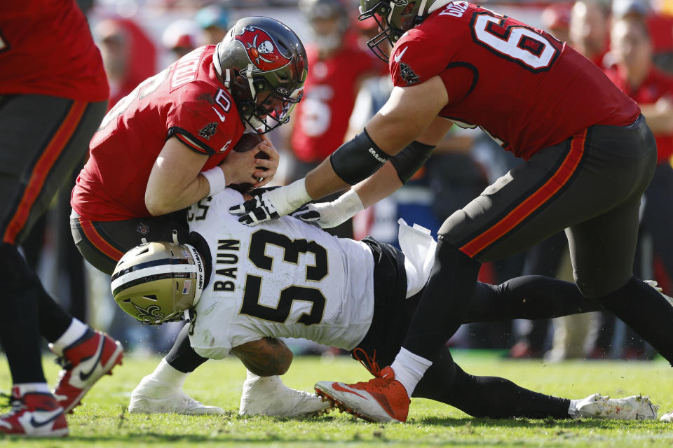 TAMPA, FLORIDA – DECEMBER 31: Baker Mayfield #6 of the Tampa Bay Buccaneers is sacked by Zack Baun #53 of the New Orleans Saints during the second quarter at Raymond James Stadium on December 31, 2023 in Tampa, Florida. (Photo by Mike Ehrmann/Getty Images)