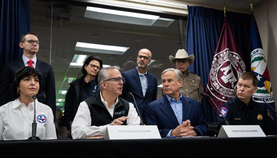 Gov. Greg Abbott, second from right, attends a news conference earlier this month. "President Biden has violated his oath to faithfully execute immigration laws enacted by Congress," Abbott wrote in a statement Wednesday.