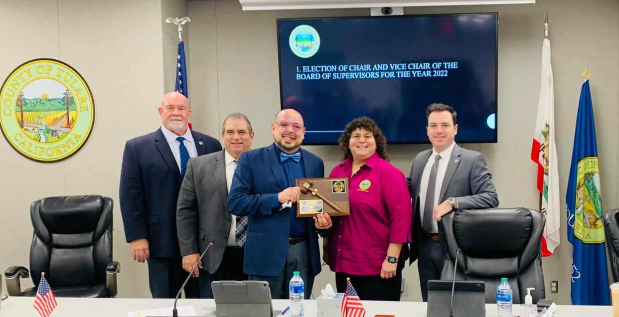 Tulare County Chairman Eddie Valero presents a gavel to 2021 Chair Amy Shuklian. Valero, who represents District 4, will serve as chairman for 2022. District 5 Supervisor Dennis Townsend will serve as vice-chair.