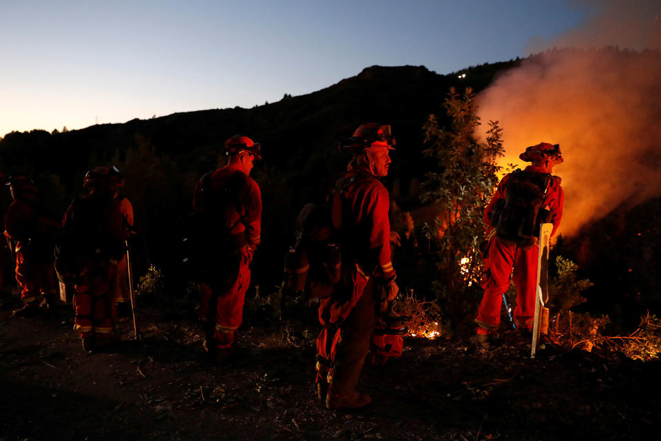<p>A hand crew with the California Department of Corrections and Rehabilitation monitor the Loma Fire along Loma Prieta Avenue near Santa Cruz, California, U.S. September 27, 2016. (Stephen Lam/Reuters) </p>