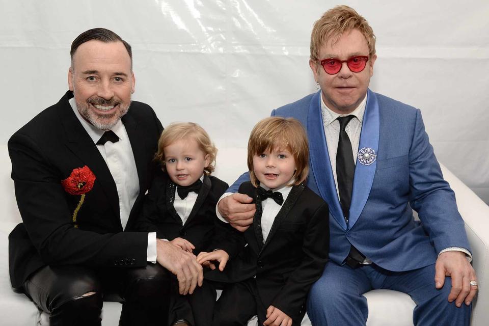 <p>Michael Kovac/Getty</p> David Furnish, Elijah Furnish-John, Zachary Furnish-John, and Elton John