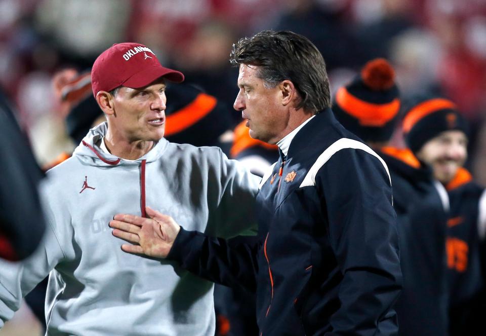 OU coach Brent Venables, left, and OSU coach Mike Gundy speak before last season's Bedlam football game in Norman. This year's meeting in Stillwater will likely be the final meeting for the foreseeable future.