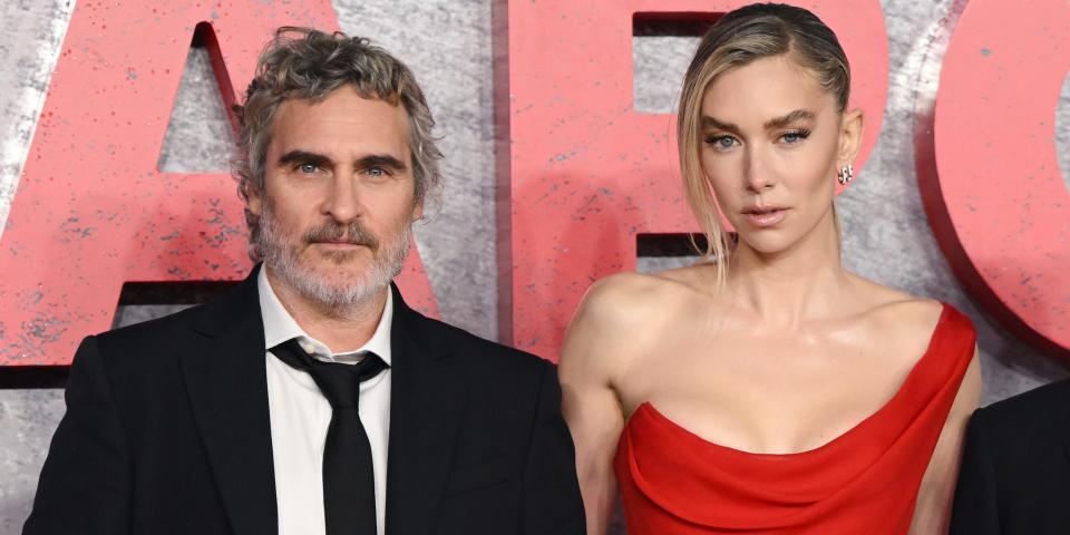 Joachim Phoenix and Vanessa Kirby are shown side by side posing for press pictures in formal wear.