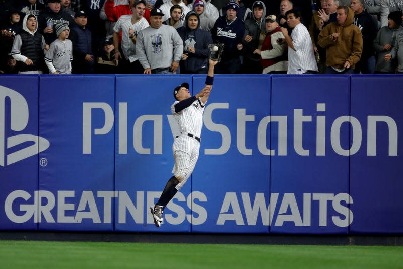 NEW YORK, NY - OCTOBER 16: Aaron Judge #99 of the New York Yankees hits the wall while making a catch against the Houston Astros during the fourth inning in Game Three of the American League Championship Series at Yankee Stadium on October 16, 2017 in the Bronx borough of New York City. 