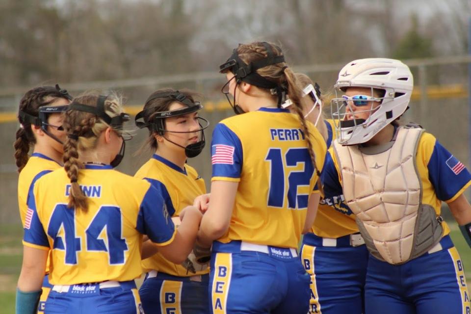 Jefferson's softball players offer encouragement for pitcher Julia Perry (12) Tuesday. She had 15 strikeouts in a 6-0 victory over Grosse Ile.