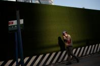 A worker leaves a construction site at the end of the workday in the Central Business District in Beijing