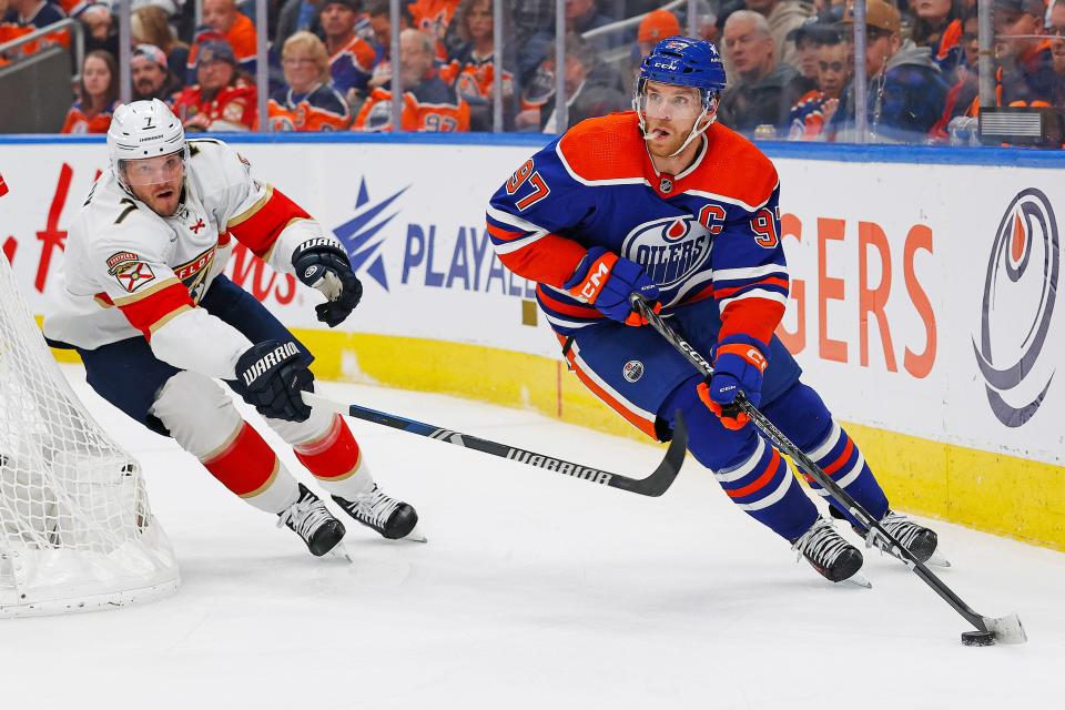 Dec 16, 2023; Edmonton, Alberta, CAN; Edmonton Oilers forward Connor McDavid (97) looks to make a pass in front of Florida Panthers defensemen Dmitry Kulikov (7) during the third period at Rogers Place. Mandatory Credit: Perry Nelson-USA TODAY Sports