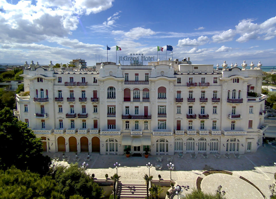 This Monday, May 11, 2020 photo shows the Rimini Grand Hotel, in Rimini, Italy. The luxury Liberty-style hotel, where carnivalesque Italian director Federico Fellini used to stay, was built in 1908. Parts of the hotel were recreated in Rome's Cinecittà film studios for some of his movies including 'Amarcord' (1973). (AP Photo/Domenico Stinellis)