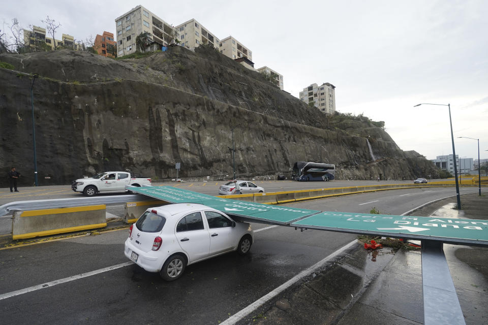 A vehicle sits damaged by a traffic sign after Hurricane Otis ripped through the area, in Acapulco, Mexico, Wednesday, Oct. 25, 2023. Hurricane Otis ripped through Mexico's southern Pacific coast as a powerful Category 5 storm, unleashing massive flooding, ravaging roads and leaving large swaths of the southwestern state of Guerrero without power or cellphone service. (AP Photo/Marco Ugarte)