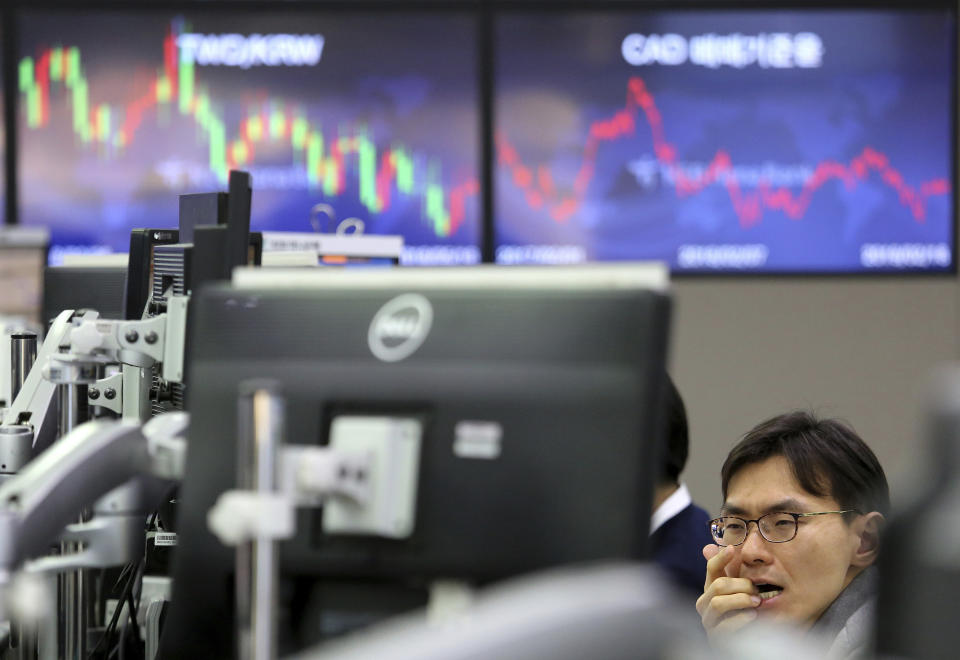 A currency trader watches monitors at the foreign exchange dealing room of the KEB Hana Bank headquarters in Seoul, South Korea, Monday, Feb. 18, 2019. Asian markets were broadly higher on Monday as traders looked forward to the continuation of trade talks between Chinese and American officials in Washington this week. (AP Photo/Ahn Young-joon)