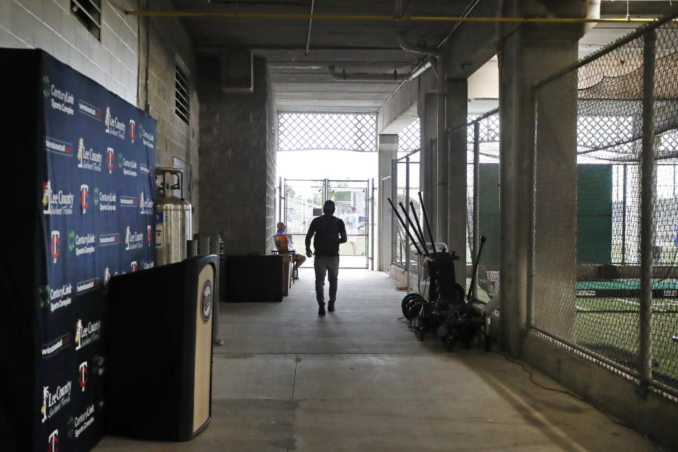 Minnesota Twins' Wilfredo Tovar walks out of Hammond Stadium, Thursday, March 12, 2020, in Fort Myers, Fla. Major League Baseball has suspended the rest of its spring training game schedule because if the coronavirus outbreak. MLB is also delaying the start of its regular season by at least two weeks. (AP Photo/Elise Amendola)
