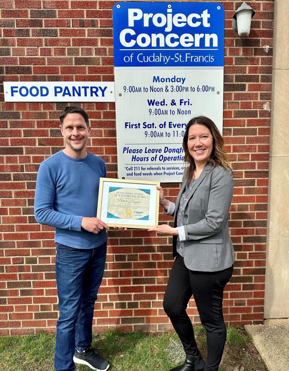 Cudahy Health Officer Heather Puente (right) presents Patrick Higgins of Project Concern of Cudahy-St. Francis with an Outstanding Public Health Partner award.