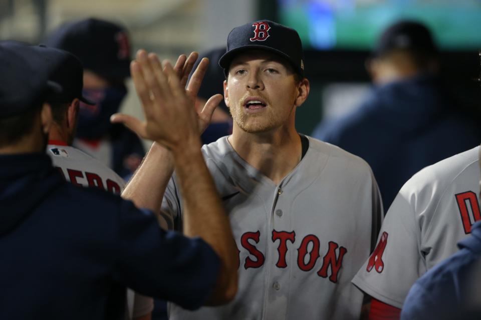 Red Sox pitcher Nick Pivetta receives high fives in the dugout after pitching five shutout innings against the Mets during a game in New York in 2021.