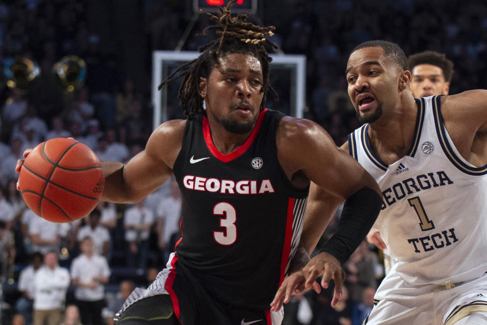 Georgia guard Kario Oquendo drives past Georgia Tech guard Kyle Sturdivant during the first half of an NCAA college basketball game Tuesday, Dec. 6, 2022, in Atlanta. (AP Photo/Hakim Wright Sr.)