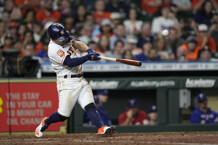 Houston Astros' Jose Altuve hits a RBI double against the Texas Rangers during the fifth inning of a baseball game Tuesday, Aug. 9, 2022, in Houston. (AP Photo/David J. Phillip)