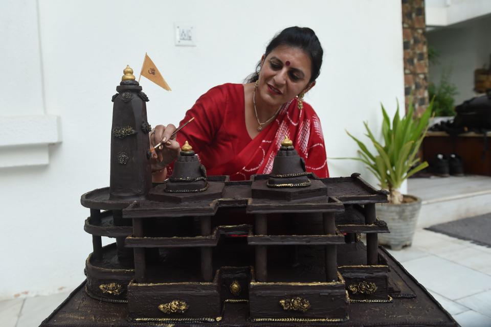 Shilpa Bhatt, 40, an entrepreneur and manufacturer-supplier of chocolates gives finishing touches to the model of Ram temple of Ayodhya on the outskirts of Ahmedabad on August 4, 2020. - Shilpa made the Ram Temple of Ayodhya chocolate model using some 15 kg chocolates in some 12 hours. (Photo by SAM PANTHAKY / AFP) (Photo by SAM PANTHAKY/AFP via Getty Images)