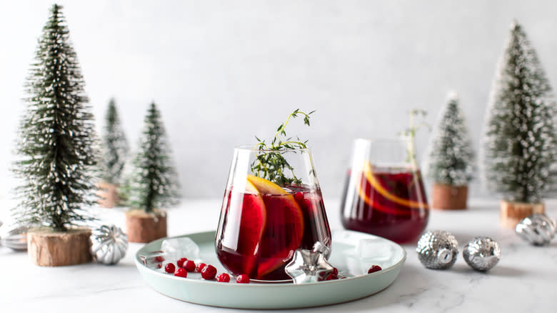 glass of cranberry juice with pine trees