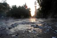 A street with traces of barricades and garbage is seen after a protest against the increase in the subway ticket prices in Santiago