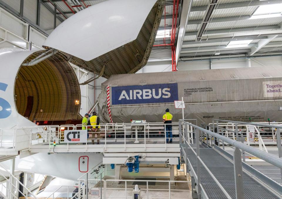 The satellite being loaded into the open nose of the Beluga freighter.