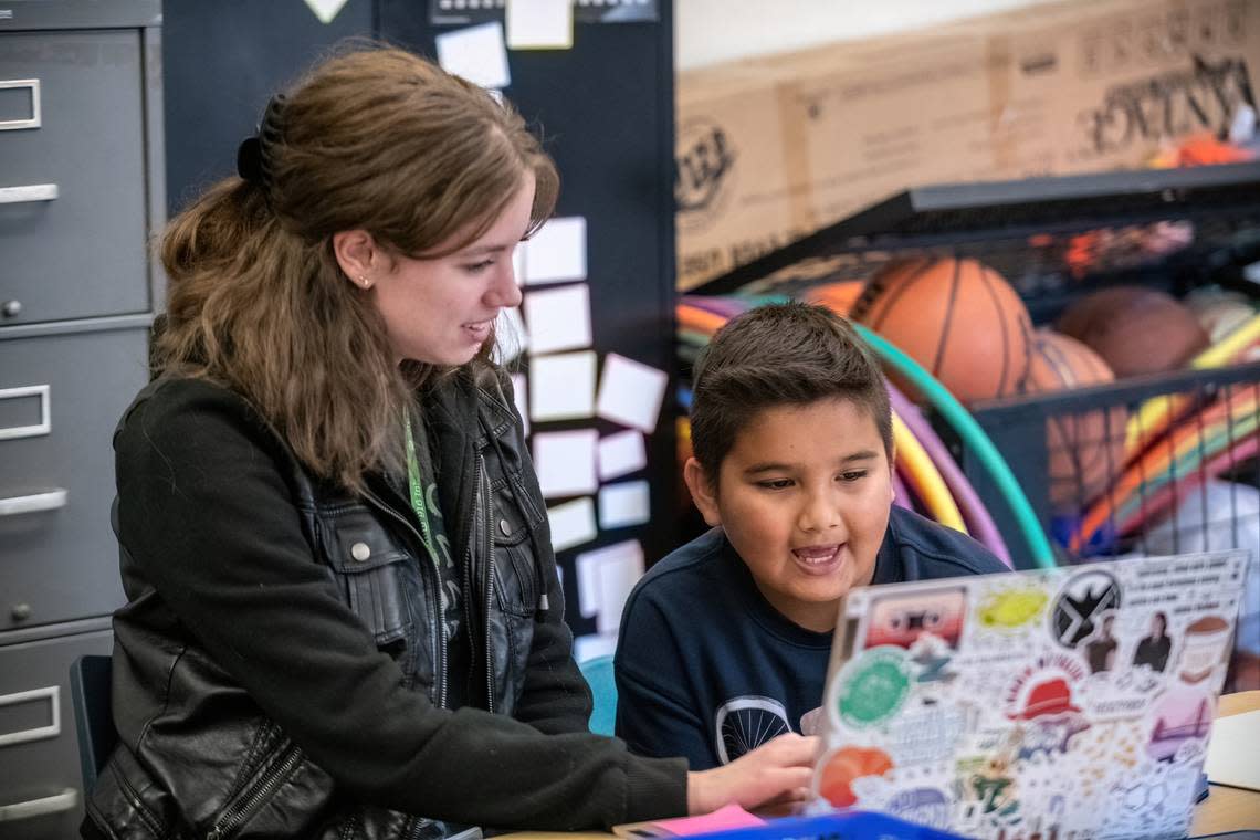 Jessica Seibold with the Read On! a literacy tutoring program of 916 Ink, works with F.C. Joyce Elementary School fifth grader, Yousuf Ghafari, on Nov. 15. 916 Ink is asking Book of Dreams readers for donations to expand its literacy tutoring programs.