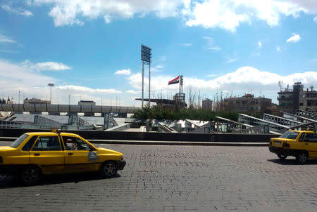 Vehicles drive at Abbasiyin square in the east of the capital Damascus, in this handout picture provided by SANA on March 20, 2017, Syria. SANA/Handout via REUTERS