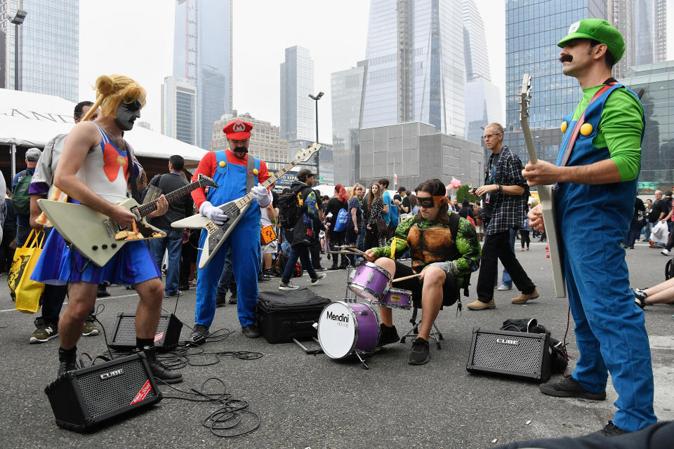 A band performs outside New York Comic Con in costume.