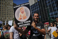 <p>A man holds a poster as he attends the nationwide “Keeping Immigrant Families Together” march on June 30, 2018 in New York City. (Photo: Kena Betancur/Getty Images) </p>