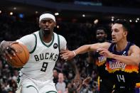 Milwaukee Bucks' Bobby Portis and Phoenix Suns' Landry Shamet go after a loose ball during the first half of an NBA basketball game Sunday, March 6, 2022, in Milwaukee . (AP Photo/Morry Gash)
