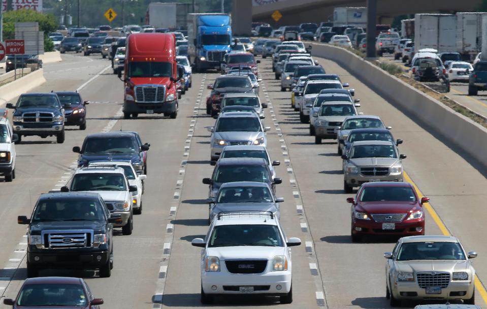 In this July 1, 2016 file photo, drivers work their way out of Dallas during rush hour. Fourth of July weekend, which is from June 30-July, is expected to be the busiest weekend for road trips in recorded history.