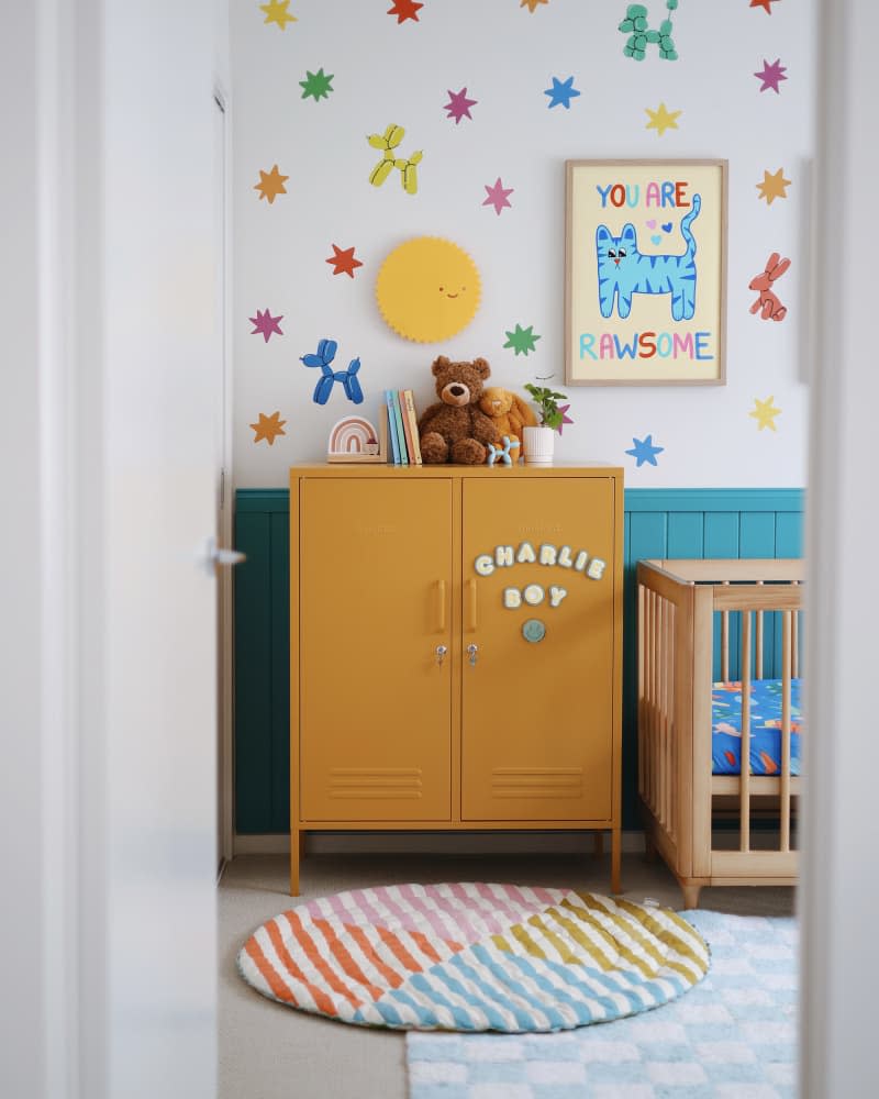 white and teal nursery with ochre colored lockers and colorful accents