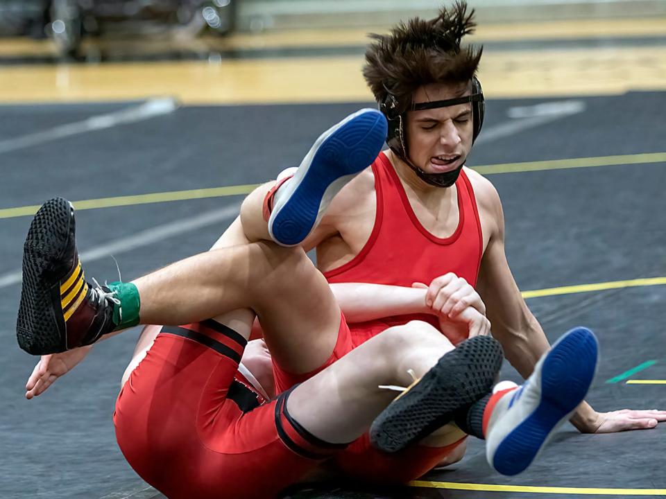 Galesburg High School senior Alex Baughman, right, competes against United High School's Ty Lafferty during the eighth annual "Red Out Night" triple dual wrestling meet with the Silver Streaks, Red Storm and Knoxville on Tuesday, Jan. 18, 2022 at John Thiel Gymnasium.