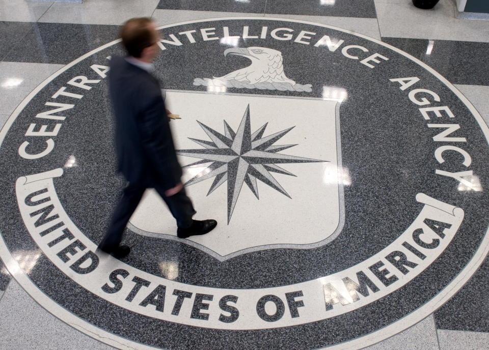 A man crosses the Central Intelligence Agency seal in the lobby of CIA headquarters in Langley, Va.