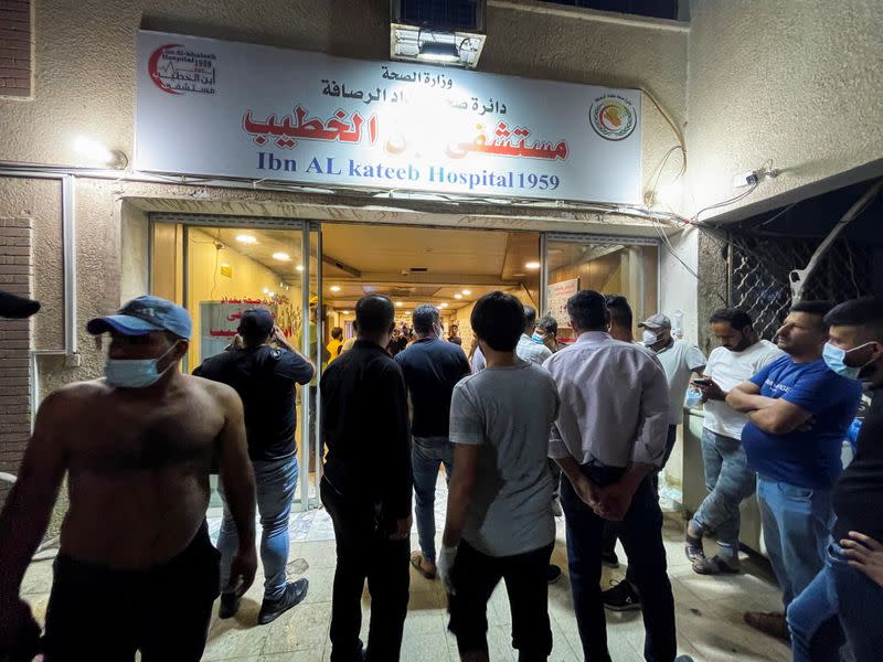 People gather at Ibn Khatib hospital after a fire caused by an oxygen tank explosion in Baghdad