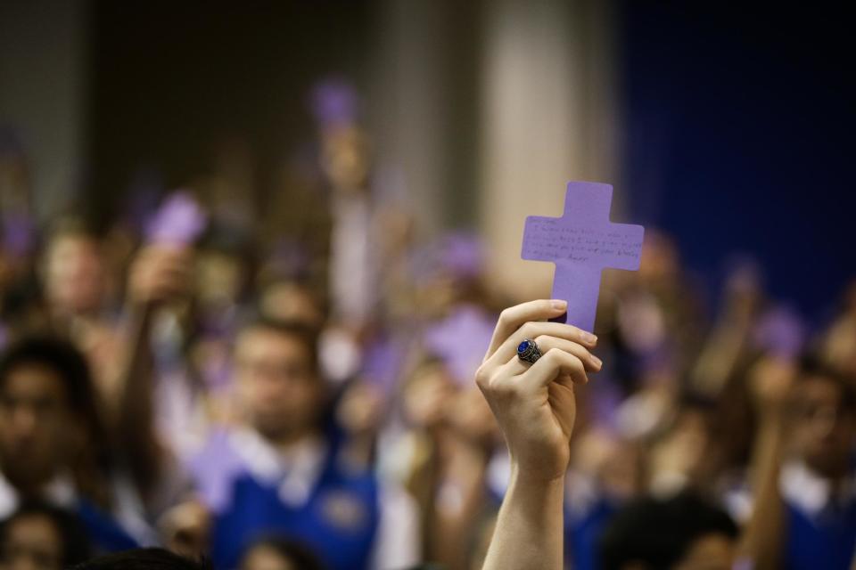 Students hold up paper crosses during an Ash Wednesday Mass at Santa Margarita Catholic High School on Wednesday, March 5, 2014, in Rancho Santa Margarita, Calif. Ash Wednesday marks the beginning of Lent, a time when Christians commit to acts of penitence and prayer in preparation for Easter Sunday. (AP Photo/Jae C. Hong)