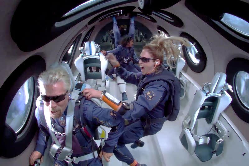 FILE PHOTO: Billionaire Richard Branson speaks as crew members float in zero gravity above Spaceport America