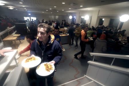 Refugees are seen at a dining room in their camp at a hotel touted as the world's most northerly ski resort in Riksgransen, Sweden, December 15, 2015. REUTERS/Ints Kalnins